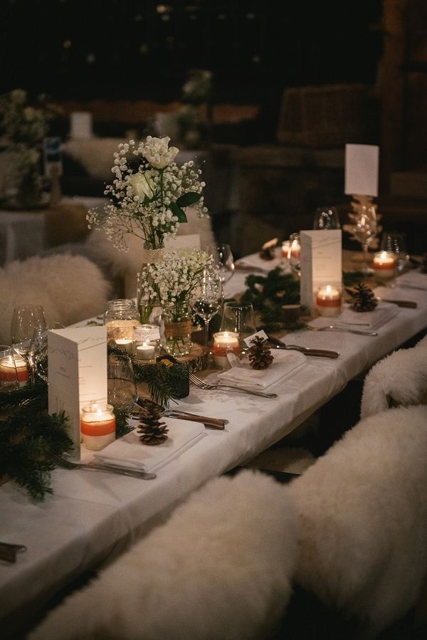 a long table with candles and flowers on it