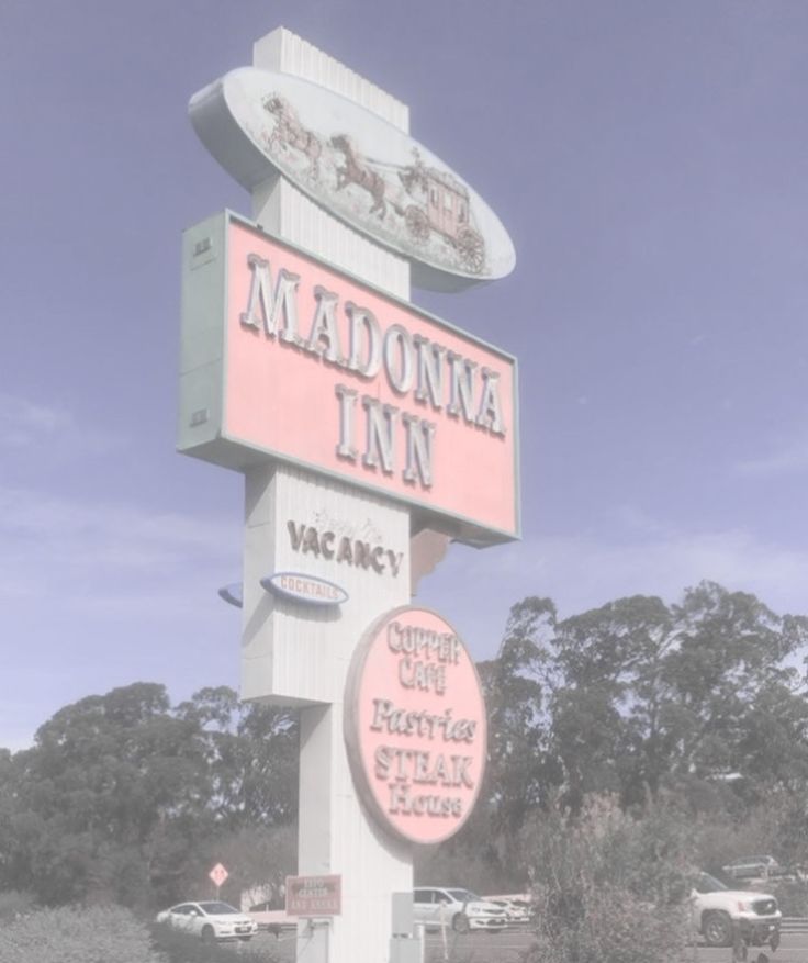 there is a pink sign that says madonna inn