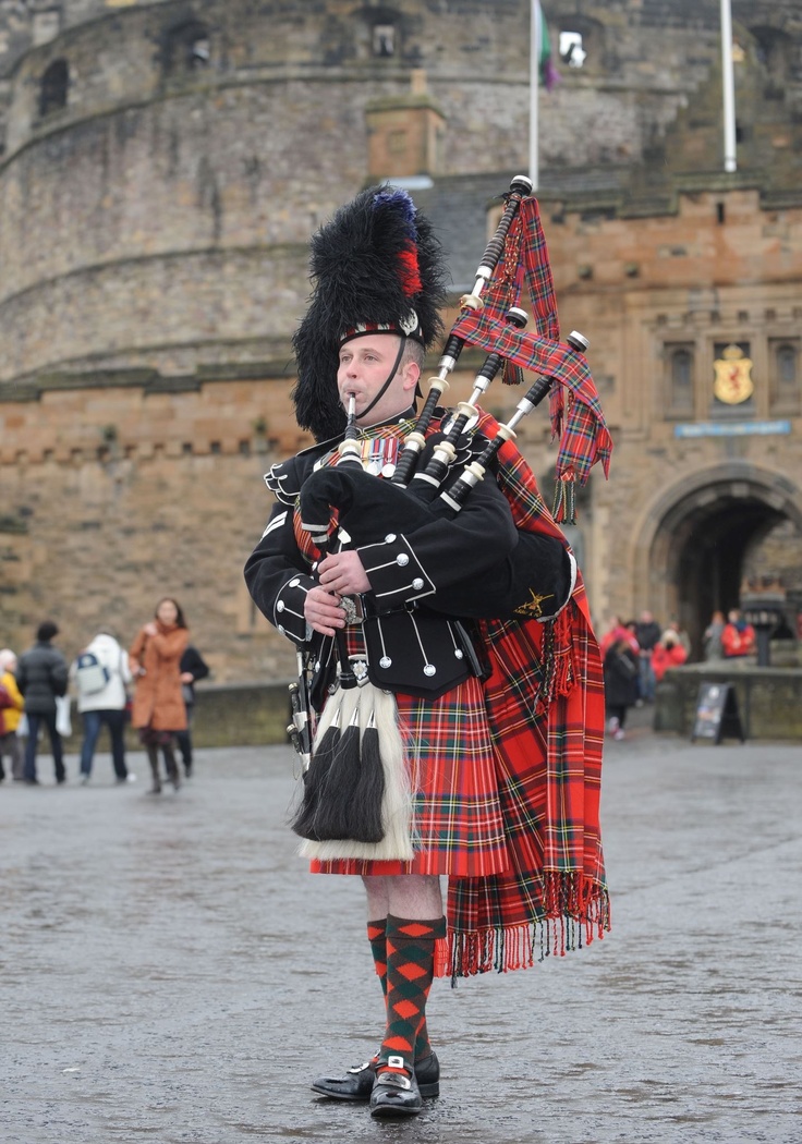 a man in a kilt playing the bagpipe