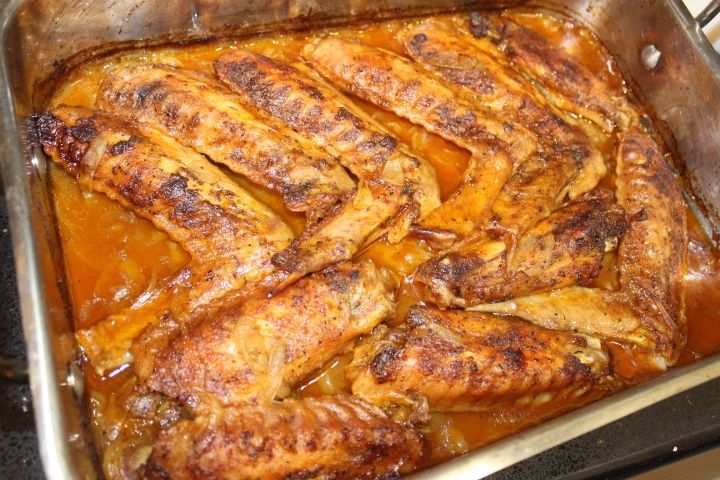 a pan filled with chicken and sauce on top of a stove