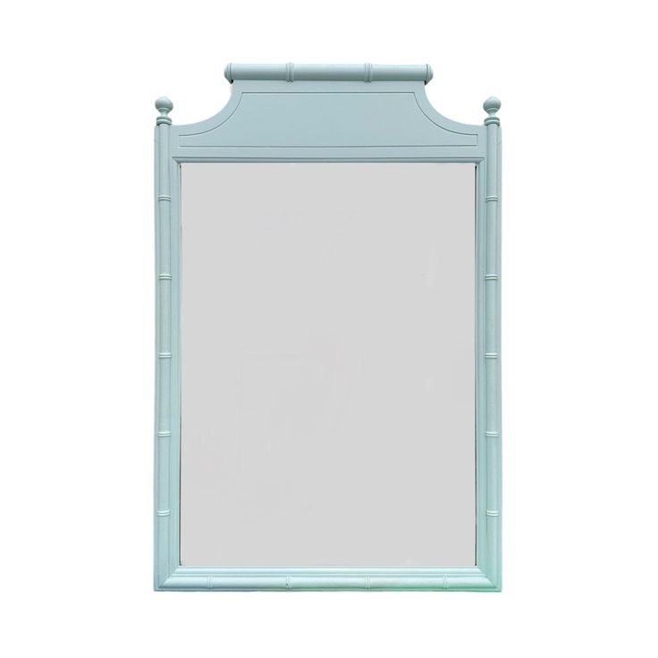 a blue bamboo framed mirror on a white wall with the reflection of it's frame