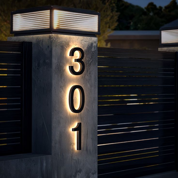 the numbers are lit up in front of a fence