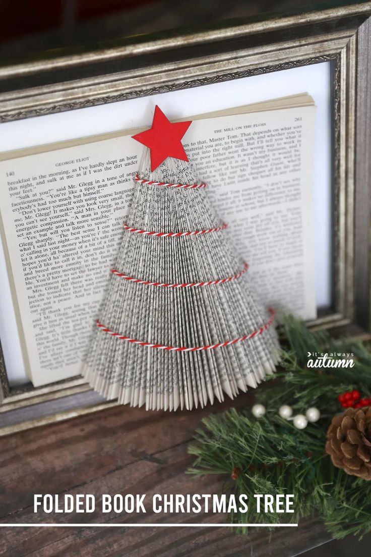 folded book christmas tree is displayed in front of an open book with the title folded book christmas tree