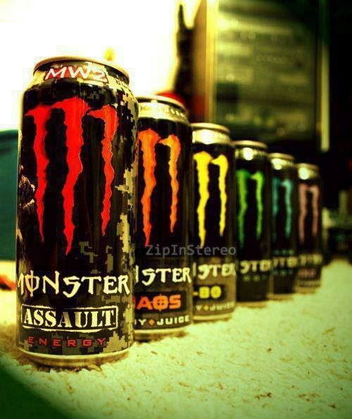 six cans of monster energy drink lined up on a counter