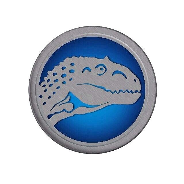 a blue and silver button with a crocodile on it's face in front of a white background