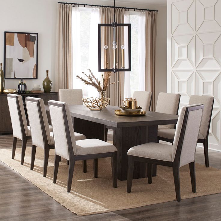 a dining room table surrounded by chairs in front of a window with beige drapes