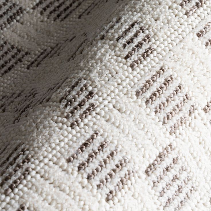 closeup of an upholstered white and brown blanket