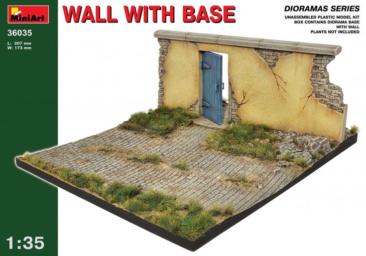 a model of a stone building with grass growing on the roof and door to it