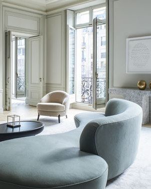 a living room filled with lots of furniture next to a fire place in a building