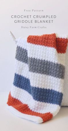 a crochet striped blanket sitting on top of a white pillow with the words crochet cumpled griddle blanket written across it