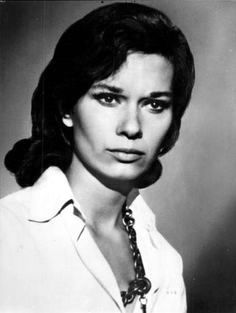 an old black and white photo of a woman wearing a shirt with a neck tie