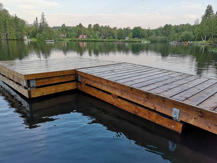 a wooden dock sitting in the middle of a lake