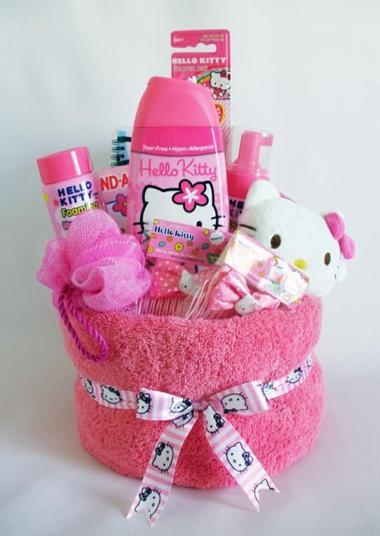 a pink hello kitty gift basket filled with personal care products and baby items for girls