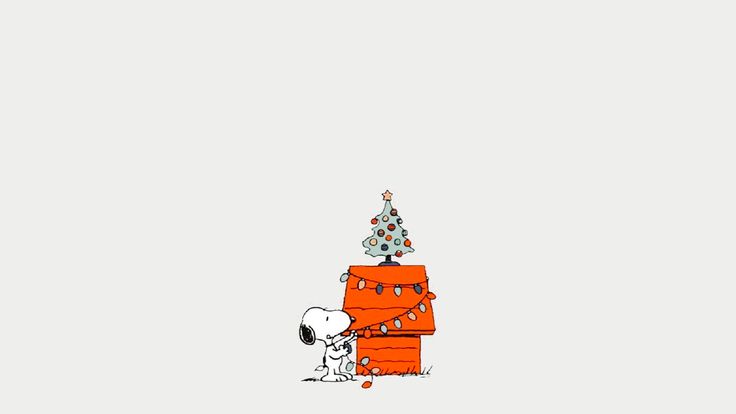 a charlie brown christmas tree on top of a stack of boxes with a dog standing next to it