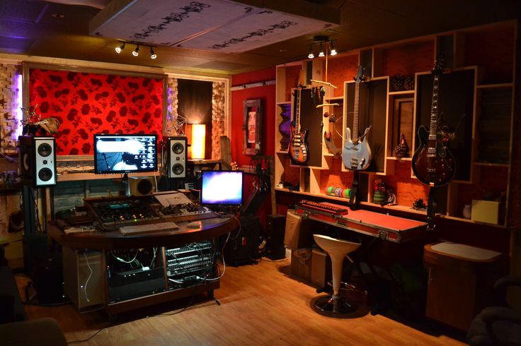 a recording studio with multiple monitors and sound equipment