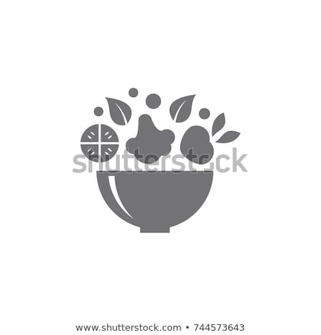 a bowl filled with fruit and leaves on a white background stock photo © shutterstocker