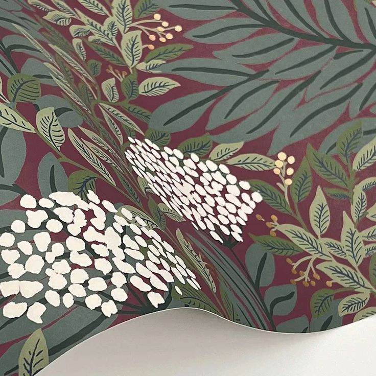 the wallpaper is very colorful and has white flowers on it with green leaves around it