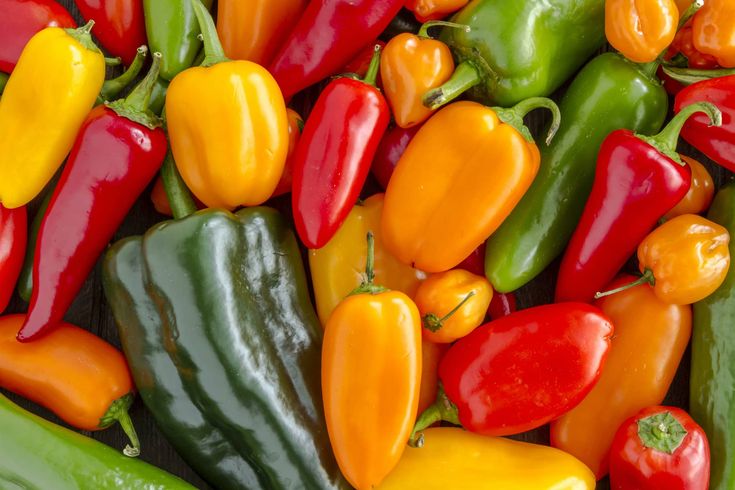 many different colored peppers are grouped together