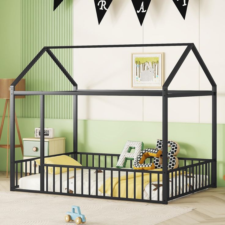 a child's bedroom with green walls and white flooring, black iron bed frame