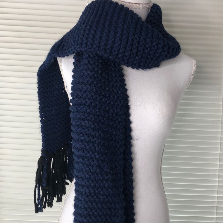 a mannequin wearing a blue knitted scarf