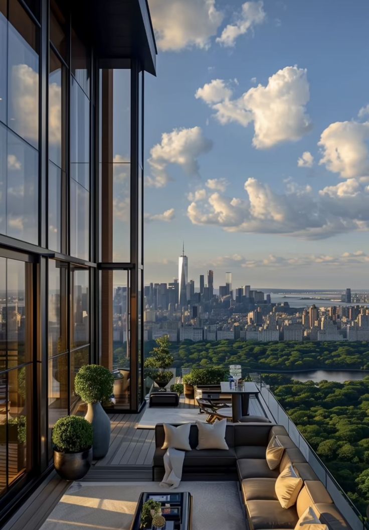 a balcony with couches and tables overlooking the city