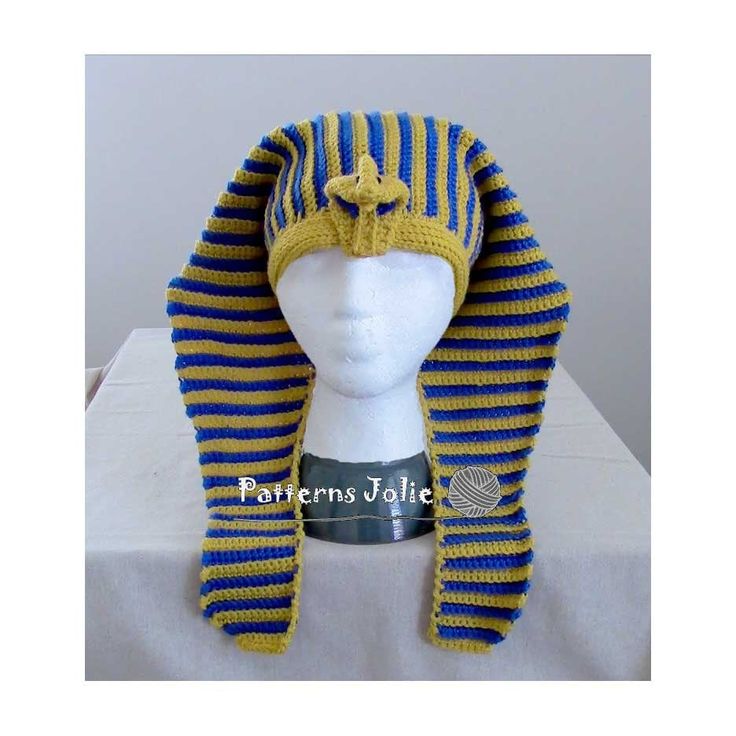 a white mannequin head wearing a blue and yellow striped knitted turban