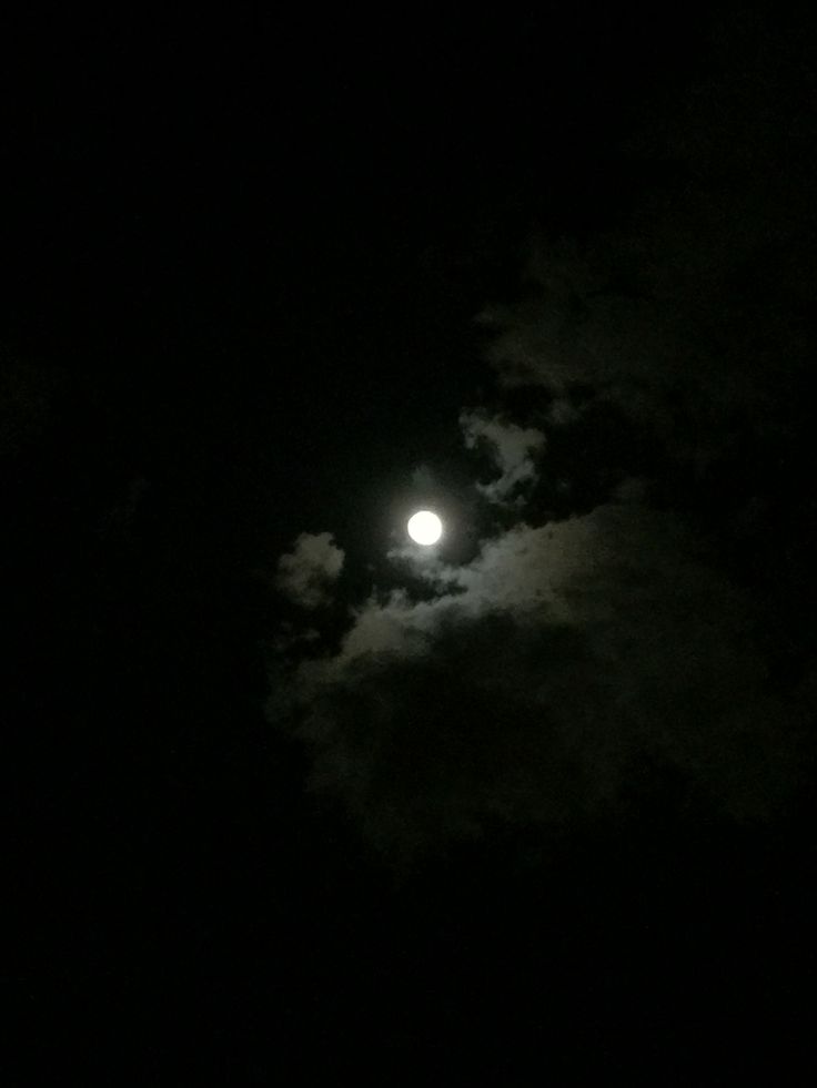 the moon is shining brightly in the dark sky