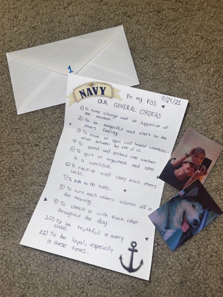 an envelope and some photos are laying on the floor next to a letter that says navy