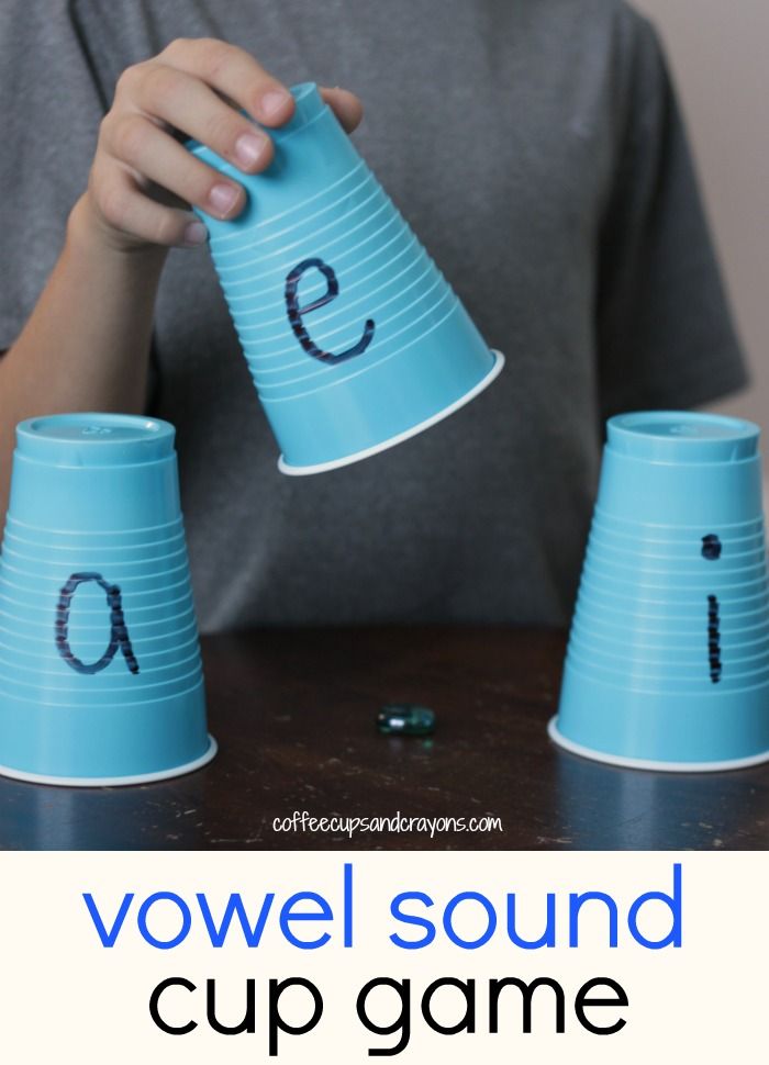 a young boy is playing with some cups that spell out the word'e '