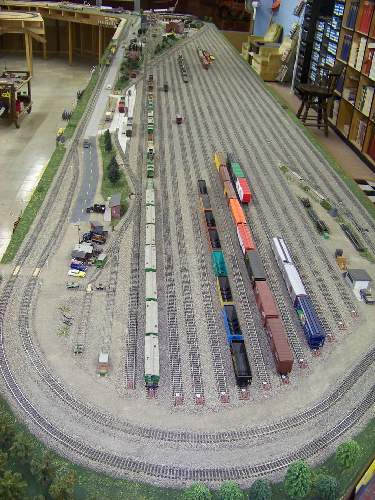 a model train yard with multiple trains on the tracks