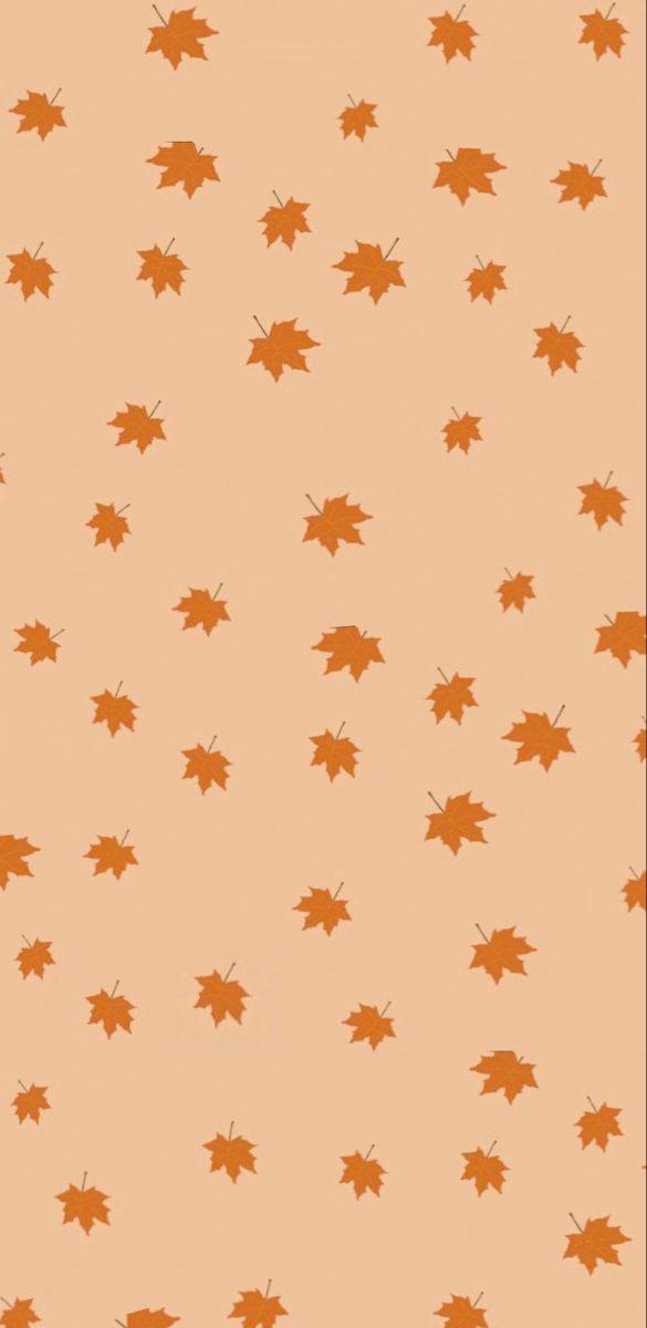 an orange background with brown leaves on it