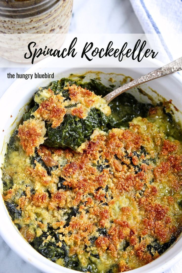 spinach and cheese casserole in a white bowl with a spoon on the side