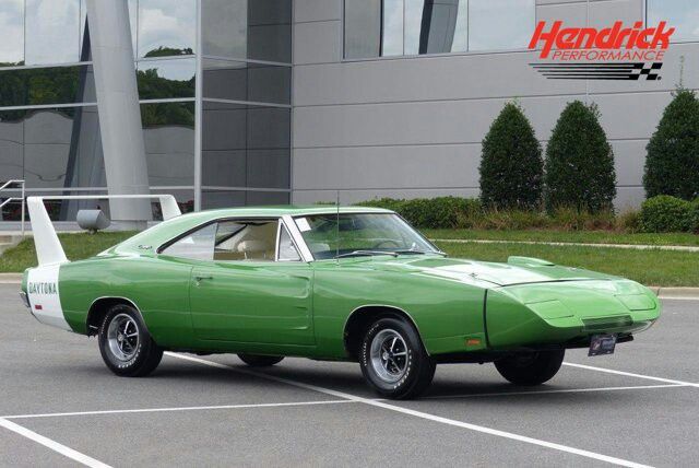 a green car is parked in a parking lot