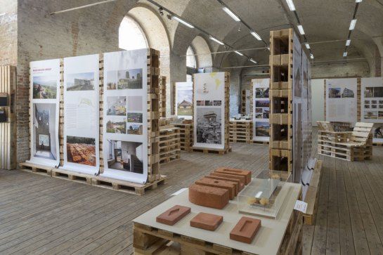 a room filled with lots of wooden pallets covered in pictures and books on top of them