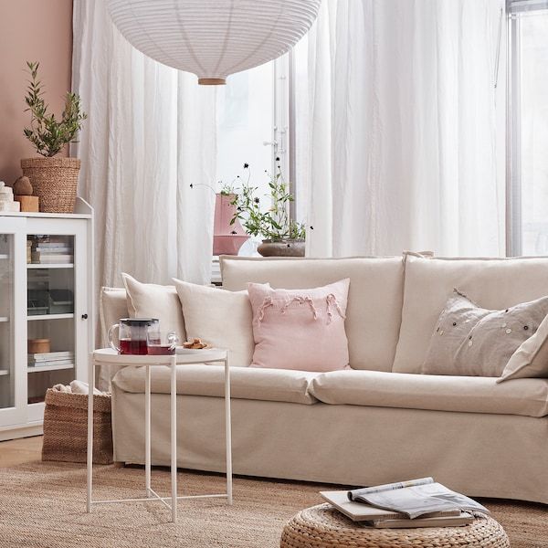 a living room filled with furniture and a white book shelf in front of a window