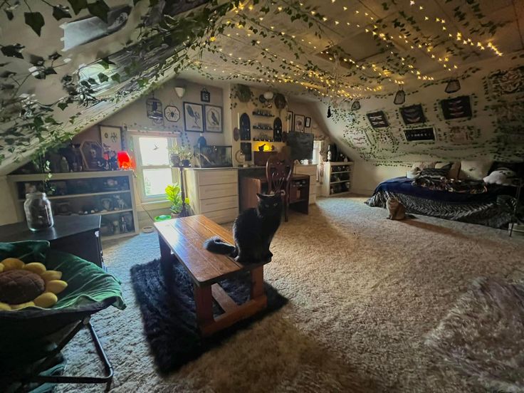 an attic bedroom with lights strung from the ceiling and decorations on the walls above it