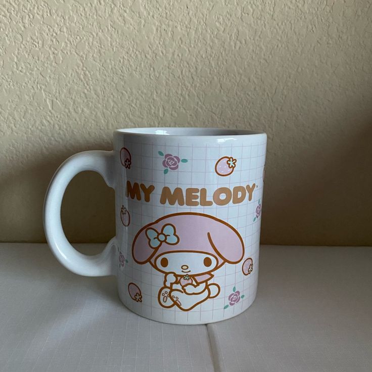 a white coffee mug with an image of a dog on the side and words that say, my melody