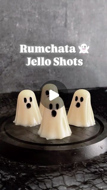 three white ghost cakes sitting on top of a black plate with the words rumchata & jello shots