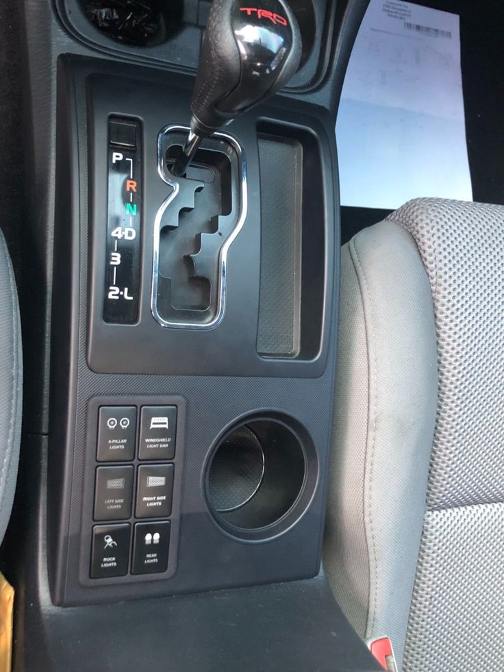 the interior of a car with an automatic gear box and control knobs on it