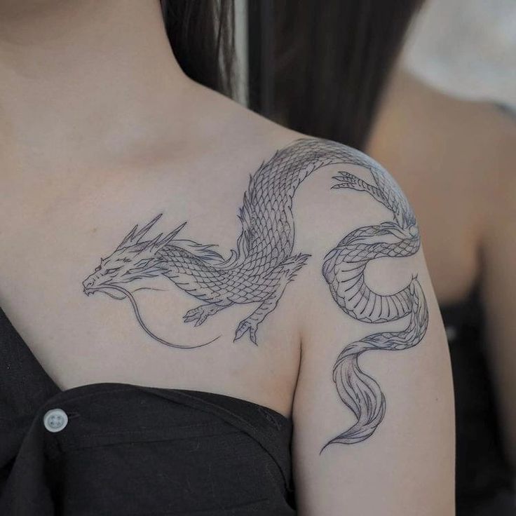 a woman with a dragon tattoo on her shoulder