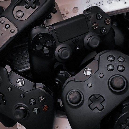 several video game controllers laying on top of each other