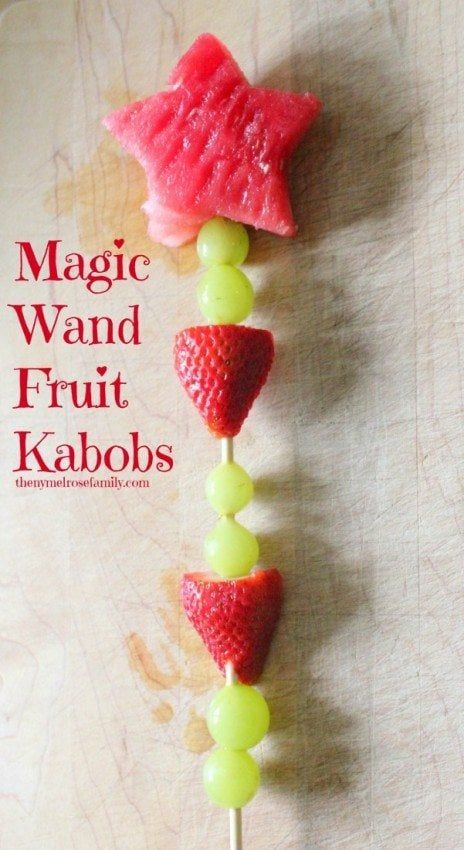 a close up of a candy bar with strawberries and grapes on it, as well as the words magic wand fruit kabobs