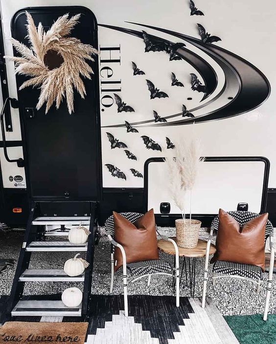 a black and white living room decorated with pumpkins, bats and other decor items