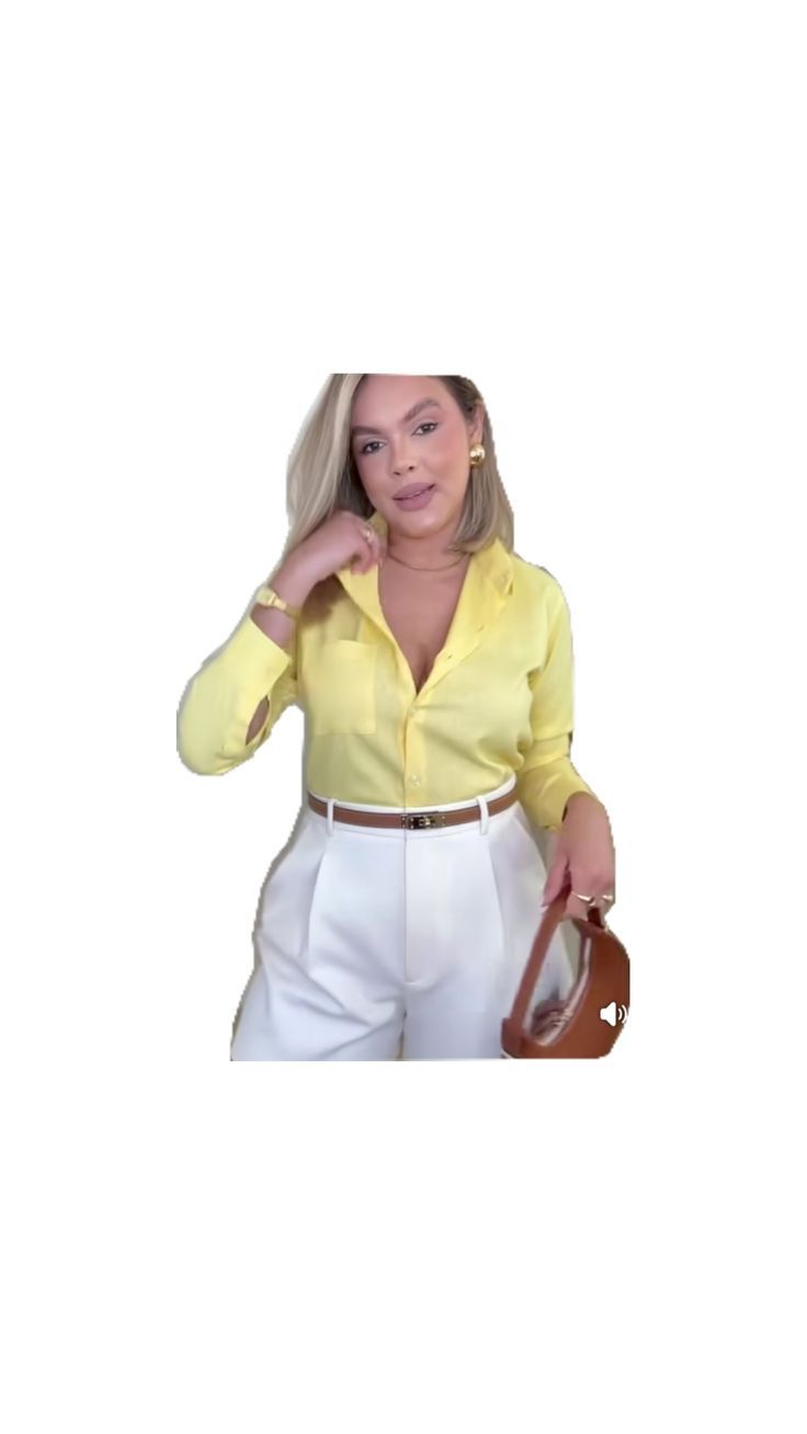 a woman in yellow shirt and white pants holding a brown purse with her right hand