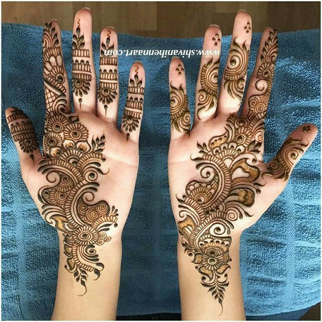 two hands with henna tattoos on them