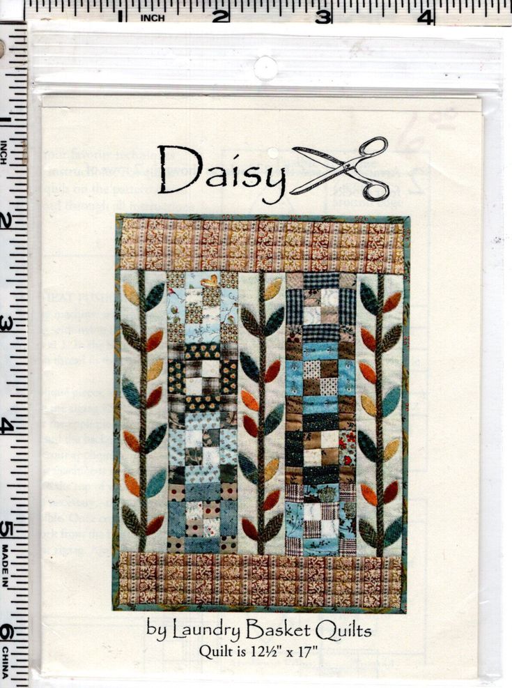 the pattern for daisy quilts is shown in front of a ruler with scissors on it