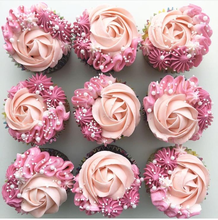 cupcakes with pink frosting and flower decorations