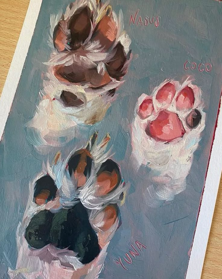 a painting of two dogs paw prints on a table