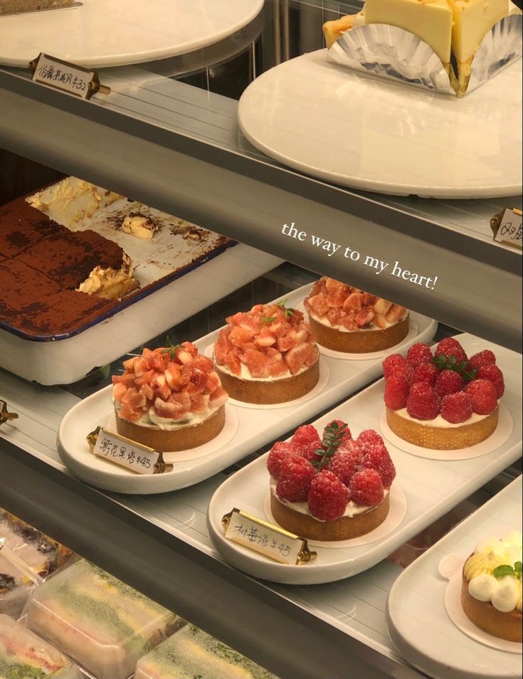 there are many desserts on display in the case