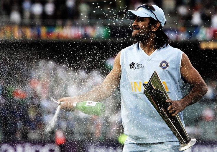 a man holding a bottle and a skateboard in the rain with water pouring on him